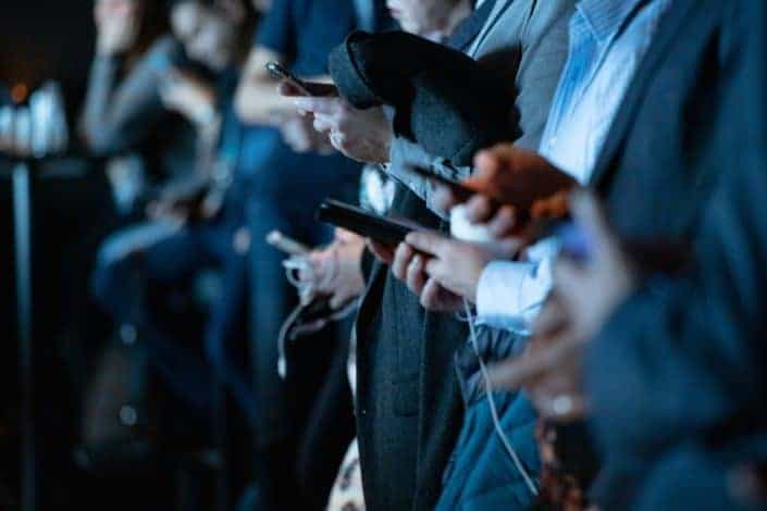 personas que usan el teléfono mientras están de pie